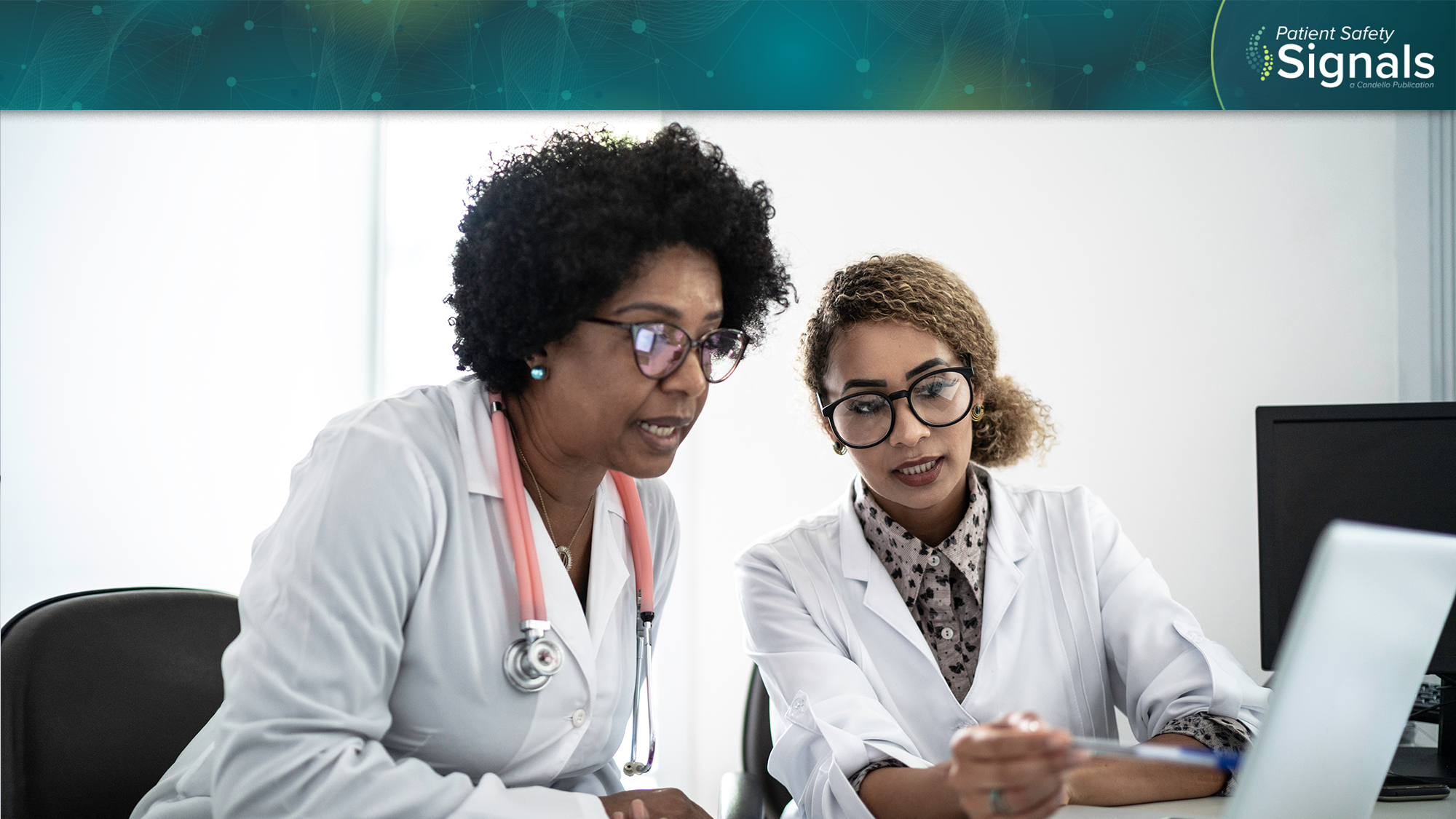 female clinicians examine a computer result