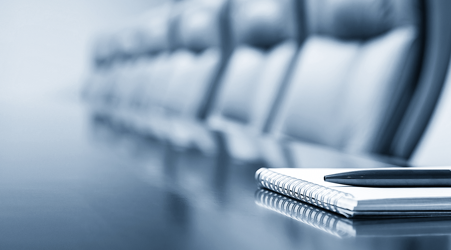board room in pale colors with a notebook and pen