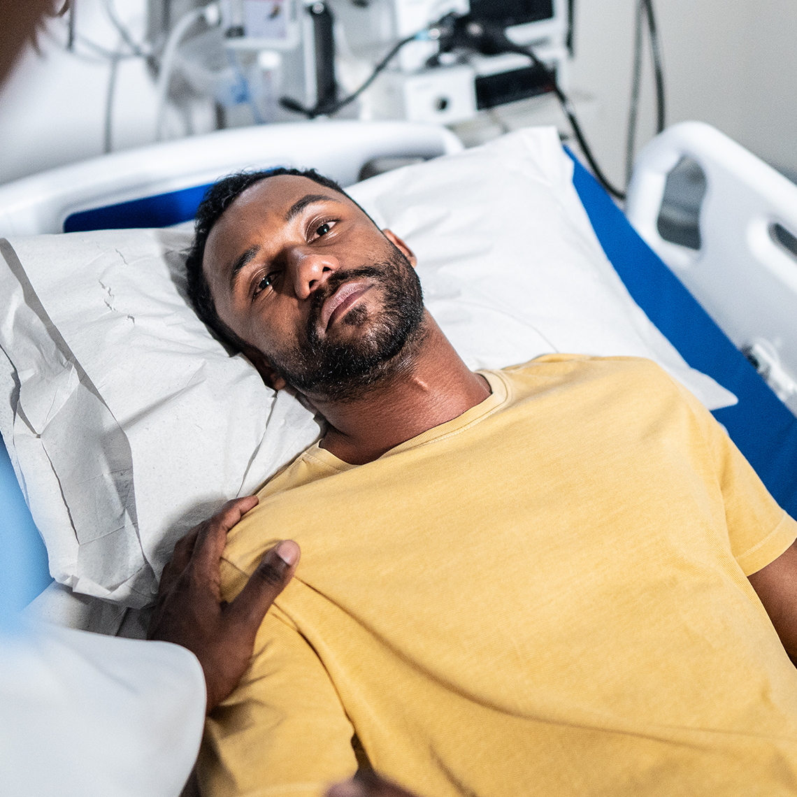 man waiting in hospital bed