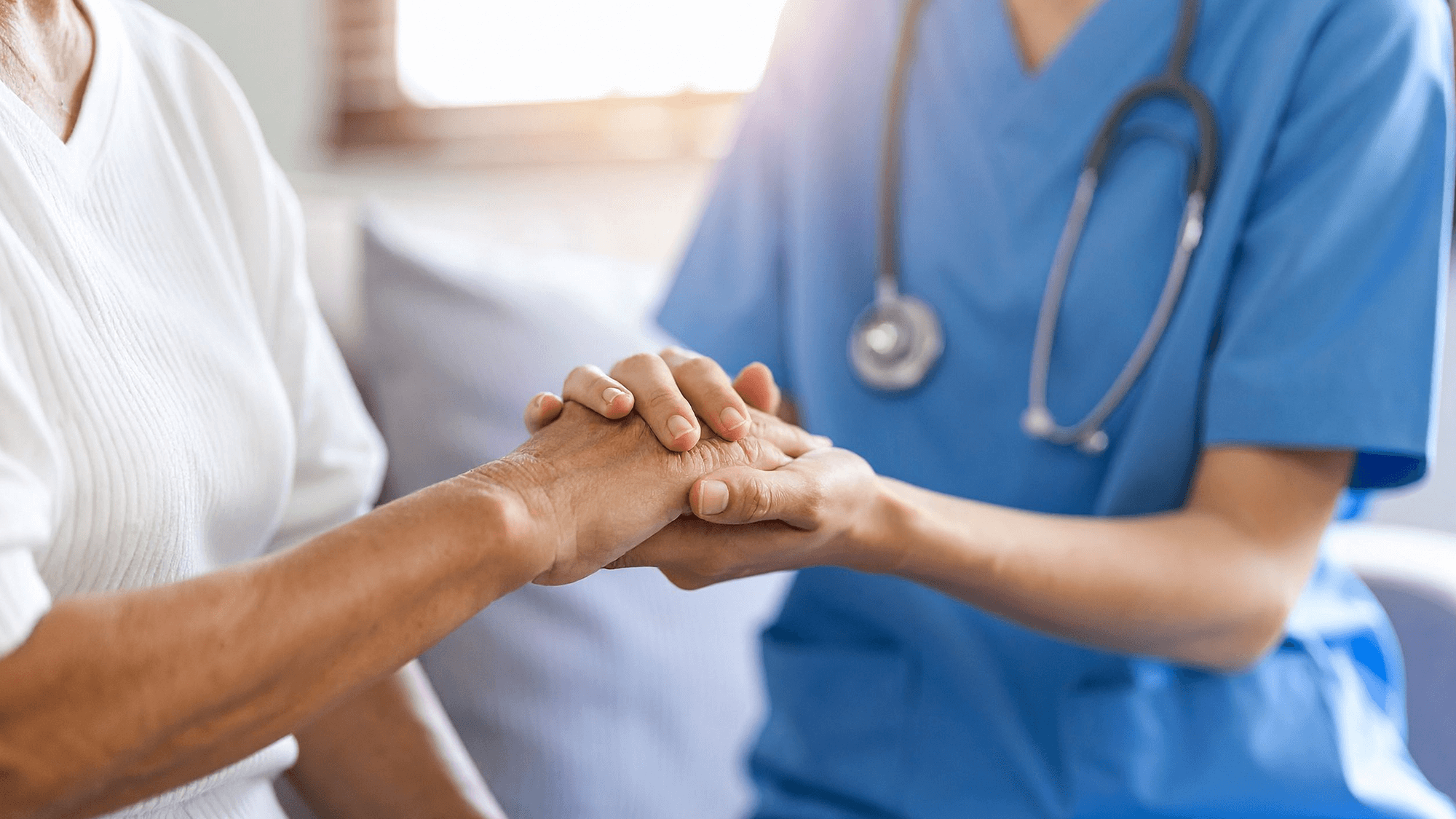 Clinician holds hand of patient