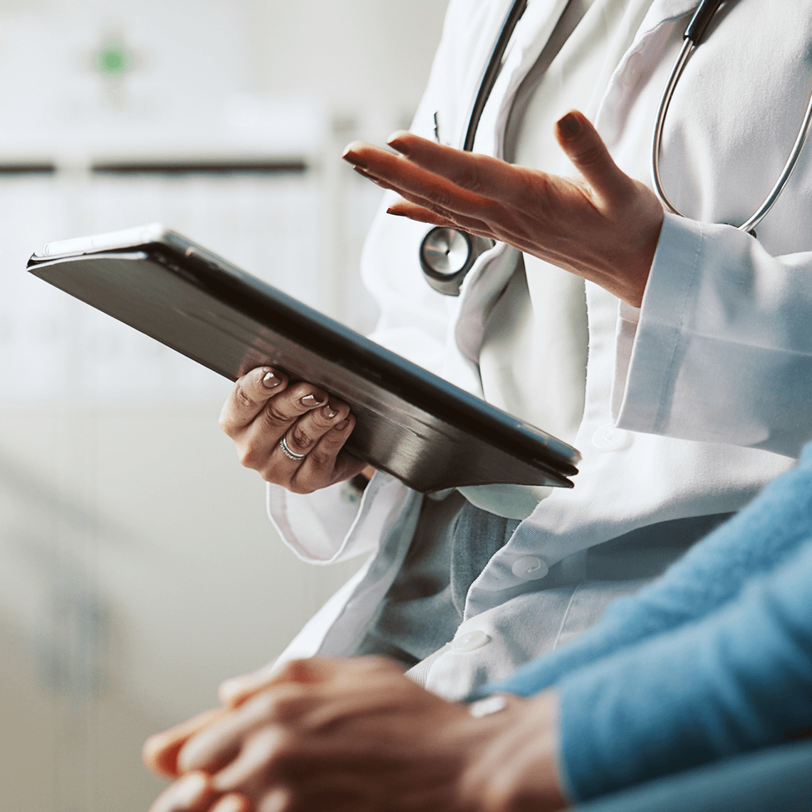 headless clinician looking a clipboard gesticulating near headless patient