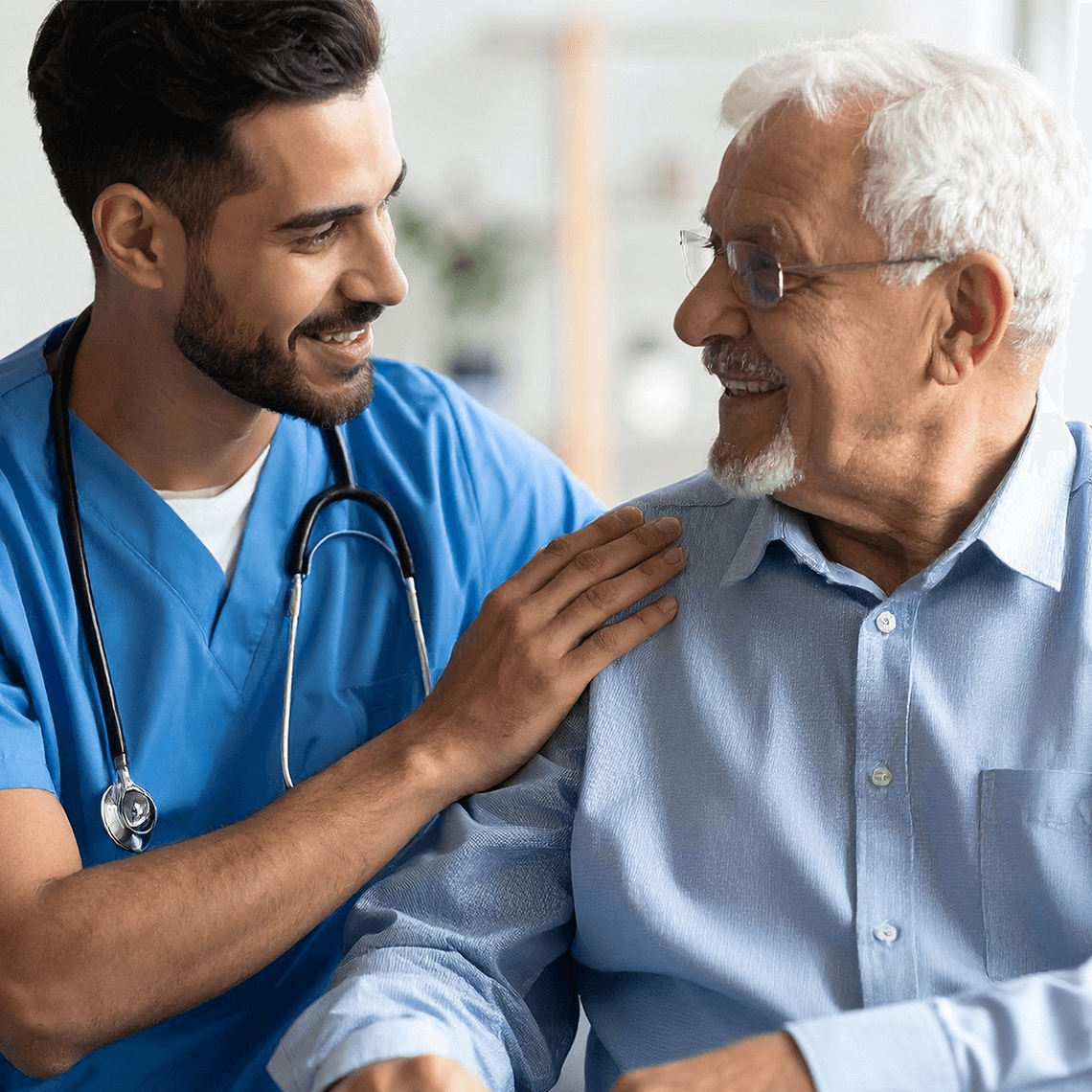 young male clinician comforts older patient